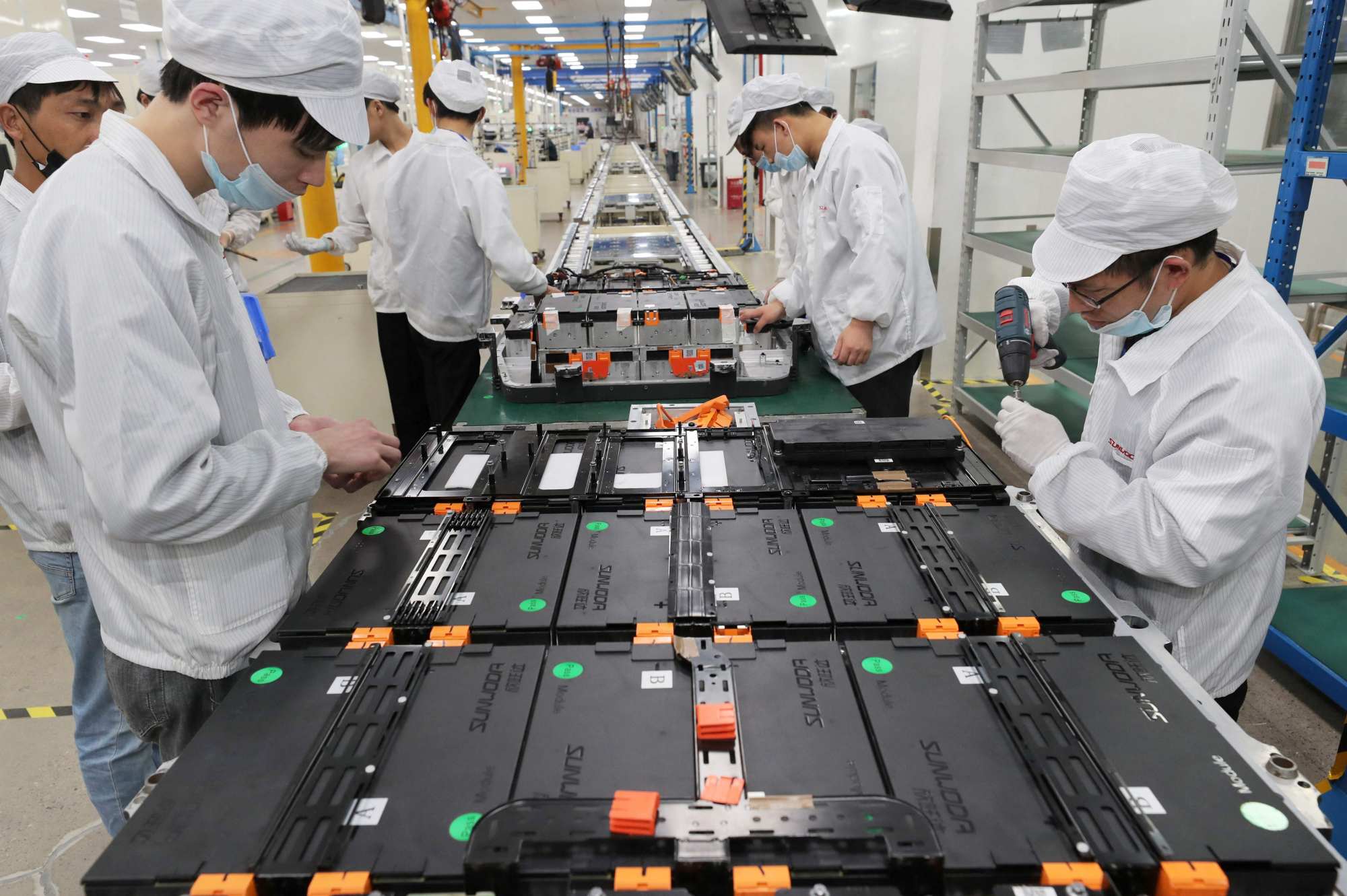 Workers check batteries at a factory for Xinwangda Electric Vehicle Battery, which makes lithium batteries for electric cars and other uses, in Nanjing in China’s eastern Jiangsu province on March 12, 2021. Photo: AFP