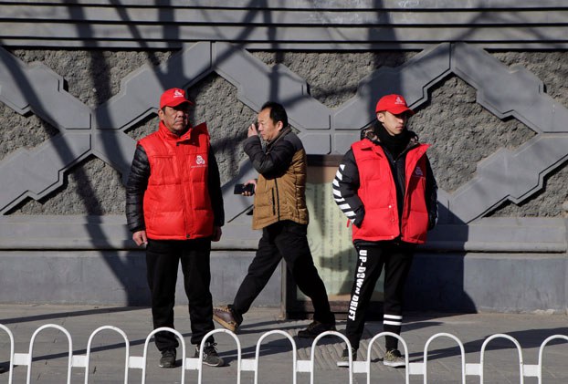 ENG_CHN_CongressCrackdown_01042024.3.jpg Local residents with red armbands, identifying them as security volunteers, keep watch near Zhongnanhai leadership compound in Beijing, March 1, 2017. (Jason Lee/Reuters)