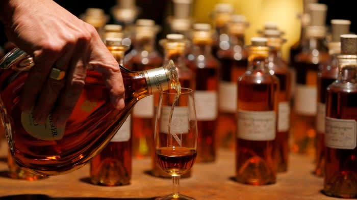 Cognac is poured into glasses at Courvoisier’s distillery in Cognac, France