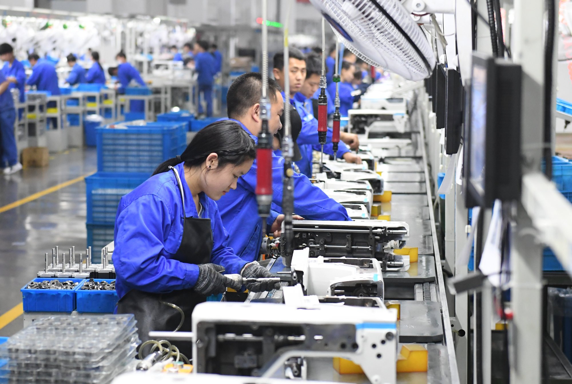 Workers are seen at Jack Sewing Machine Co., Ltd. in Taizhou, Zhejiang province. File photo: Xinhua