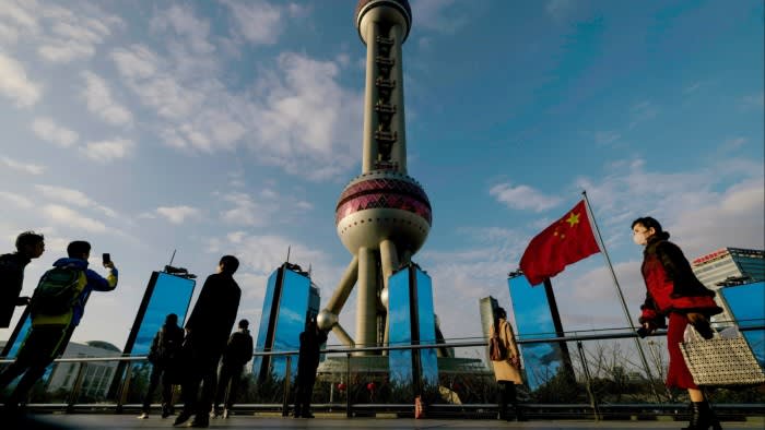 People walk below Oriental Pearl Tower in the Liuiazui financial hub, in Shanghai, China