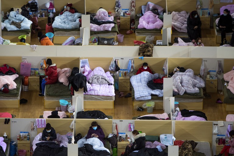 ENG_CHN_LockdownAnniversary_01242024.3.jpg Patients infected with COVID-19 rest at a temporary hospital in the Wuhan Sports Center, Feb. 17, 2020. (Xiao Yijiu/Xinhua via AP)