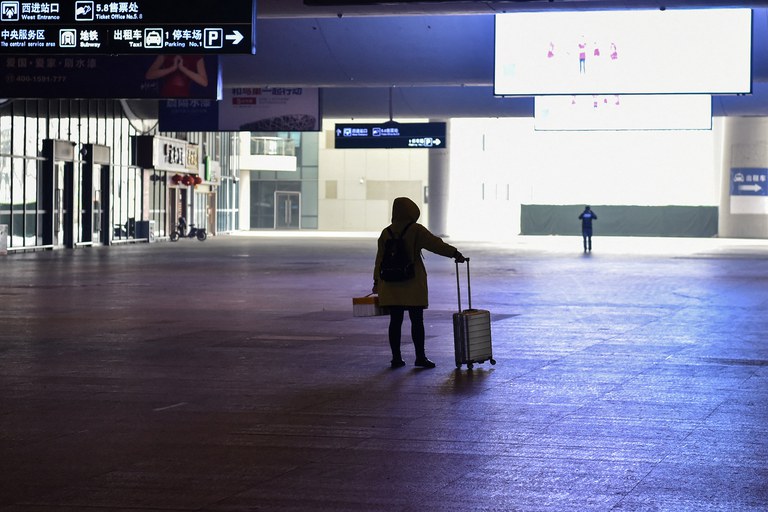 ENG_CHN_LockdownAnniversary_01242024.4.jpg A passenger arrives at the nearly deserted Wuhan train station, usually full of passengers ahead of the Lunar New Year, on Jan. 23, 2020. (Hector Retamal/AFP)