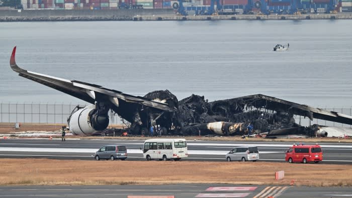 Wreckage of the JAL Airbus A350 on the tarmac at Haneda airport in Tokyo on Wednesday