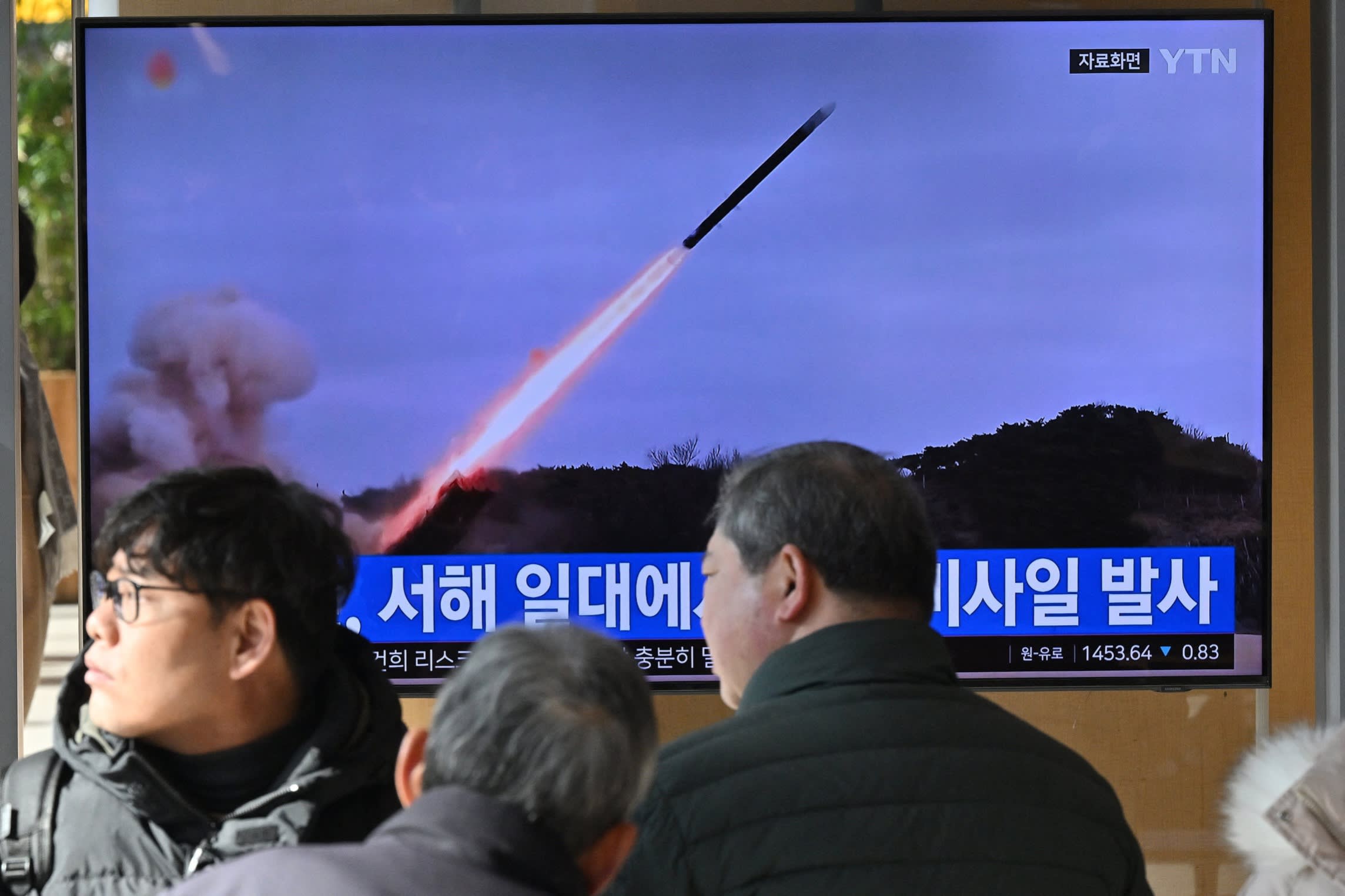 A TV screen in Seoul shows footage of a missile launch