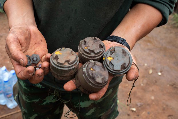 ENG_BUR_LandmineDangers_12282023.2.jpg A member of the anti-junta Karenni Nationalities Defense Force holds landmines planted by the Myanmar military and removed during demining operations near Pekon township in Myanmar's southern Shan state, July 11, 2023. (AFP)