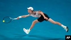 Jannik Sinner of Italy hits a forehand to Daniil Medvedev of Russia during the men's singles final at the Australian Open tennis championships at Melbourne Park, in Melbourne, Jan. 28, 2024.