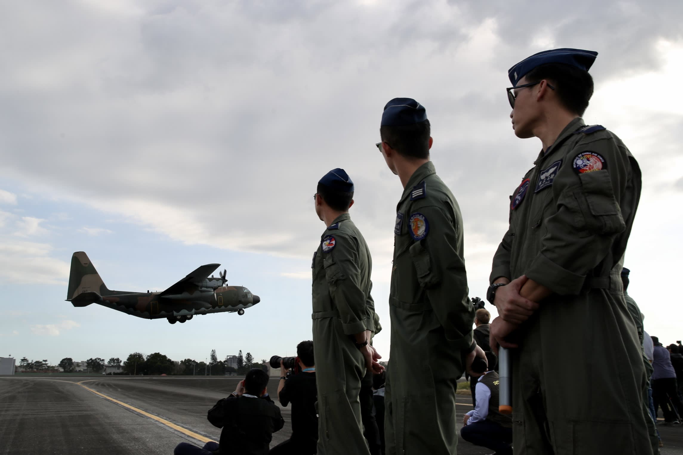 Taiwan air force personnel watch a C-130 Hercules aircraft take off during drills at an airbase in Pingtung on Tuesday