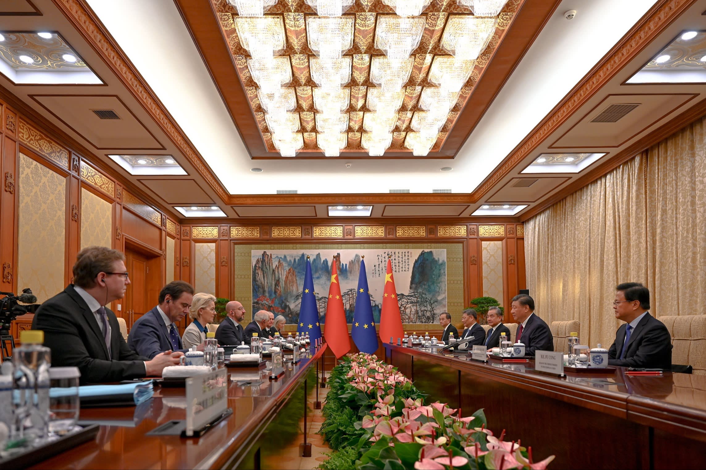 Xi Jinping and Ursula von der Leyen and their delgations sit either side of a long table during a meeting in Beijing inDecember