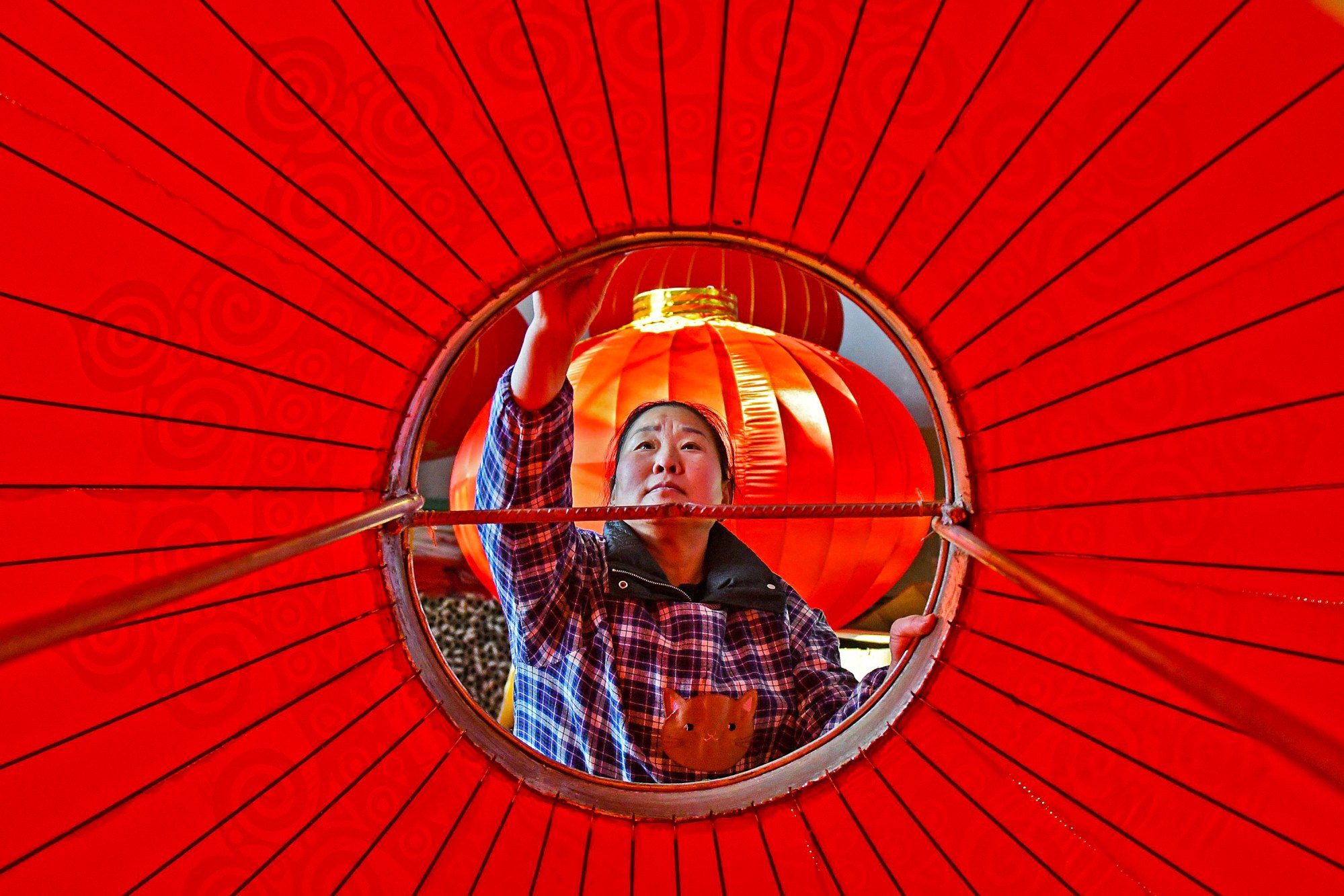 A worker produces lanterns at a factory in Yantai, in eastern China’s Shandong province on January 8, 2024. Photo: AFP