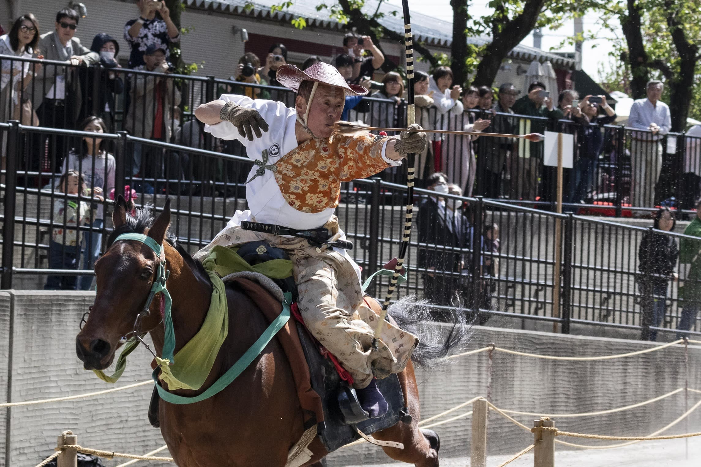 A rider wearing traditional Japanese costume participates in a horseback archery Yabusame event at Sumida Park in Asakusa