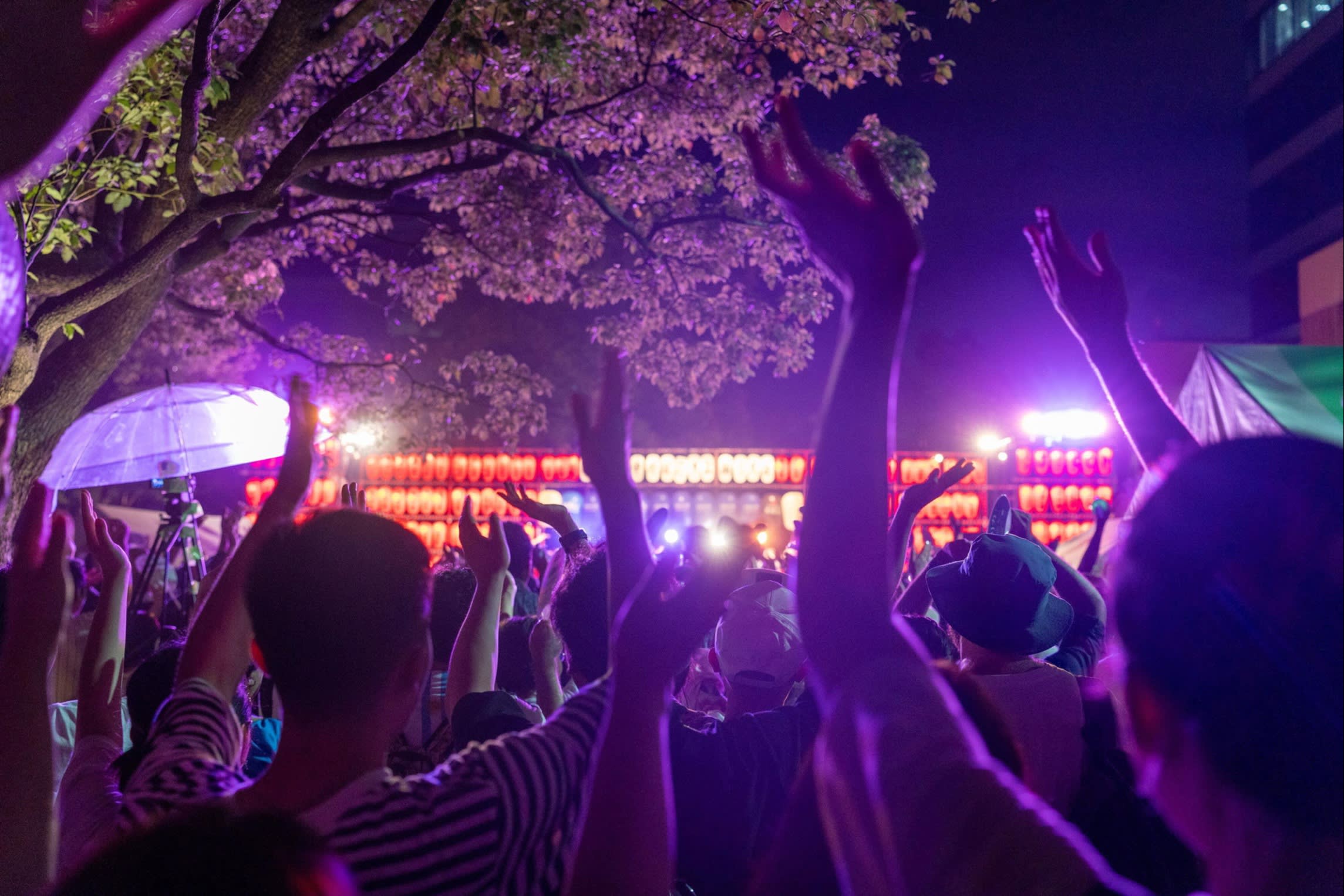 Crowds clapping along to music in front of an illuminated stage at last year’s Nakano Bon Odori festival