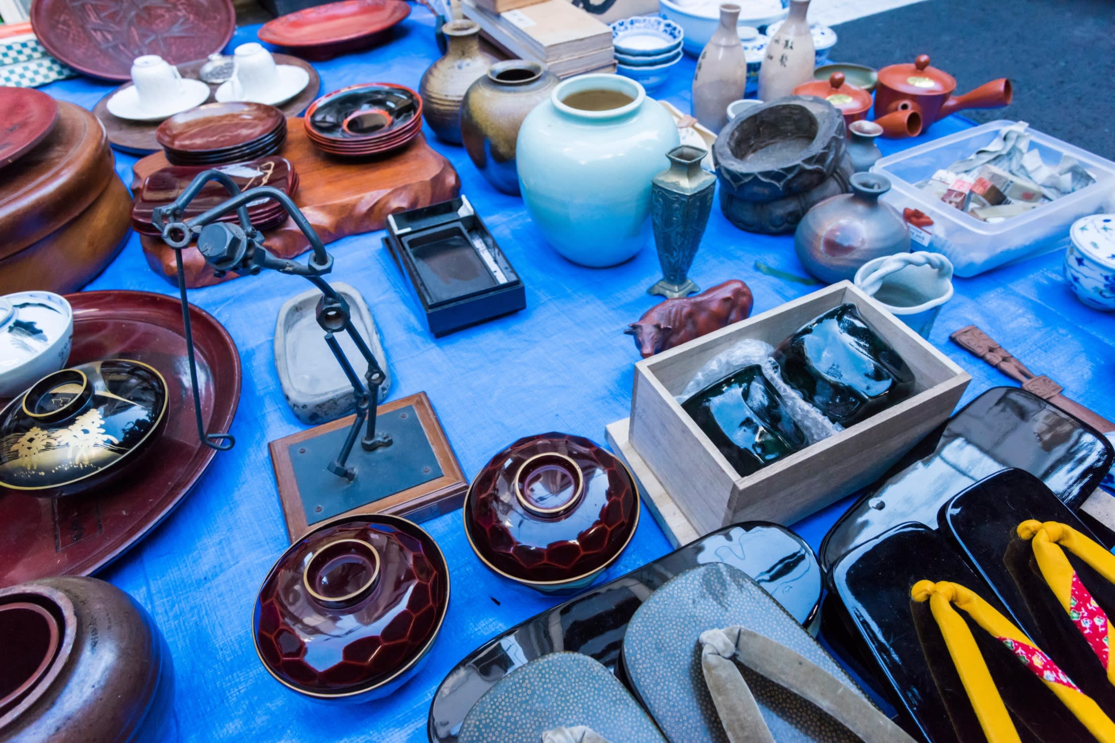 Rows of ceramics and knick-knacks on a table at the Setagaya Boroichi flea market