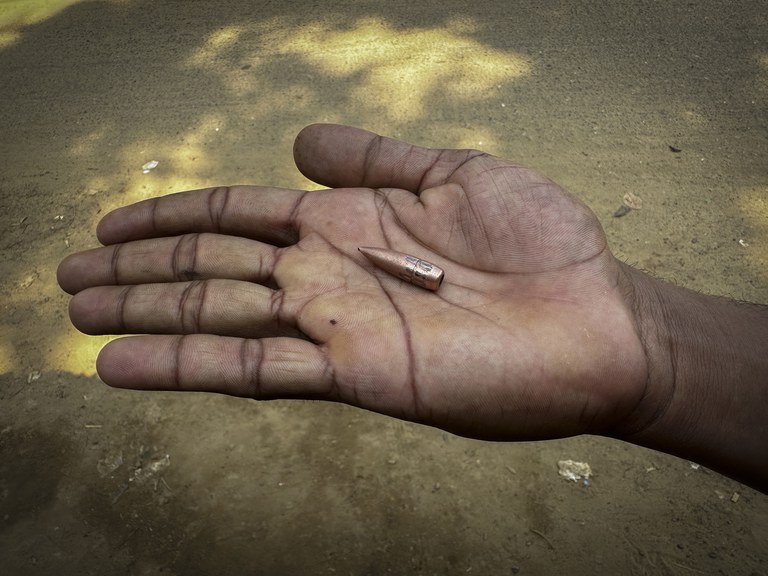ENG_BUR_AACaptureCamp_02052024.3.jpg A Bangladeshi boy displays a bullet, allegedly shot from Myanmar during fighting between Myanmar security forces and Arakan Army, in Ghumdhum, Bangladesh, on Feb. 5, 2024. (Shafiqur Rahman/AP)