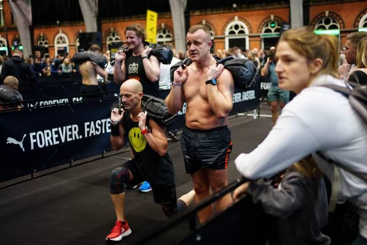 Competitors take part in the sandbag lunges section of the Hyrox competition