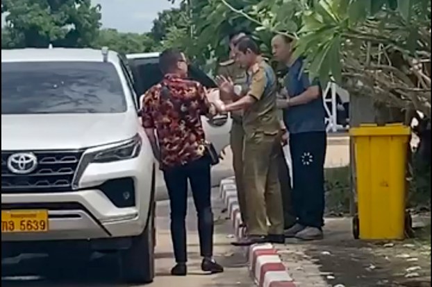 ENG_CHN_TransnationalRepression_02202024.2.jpg One of two activists (L), traveling with Chinese rights lawyer Lu Siwei (R) argues with police who were in the process of detaining Lu, near the Thanaleng dry port, south of Vientiane, Laos, July 28, 2023. Police later deported Lu to China. (Anonymous source via AP)