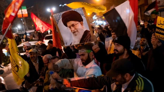 Iranian protesters carry a portrait of Iran’s Supreme Leader Ayatollah Ali Khamenei and a Yemeni flag as they tear an Israeli flag during an anti-US and anti-British protest in Tehran