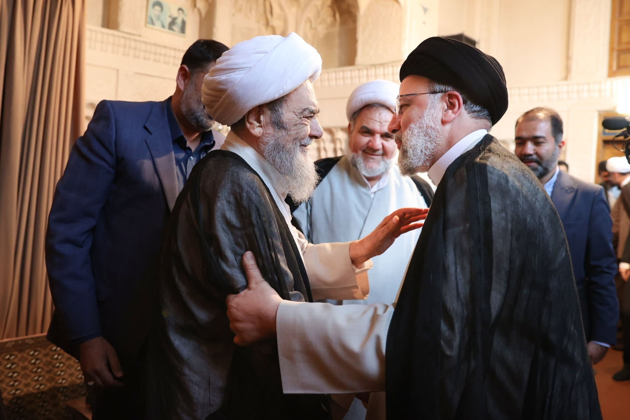 President Ebrahim Raisi, right, meets Grand Ayatollah Hossein Mazaheri