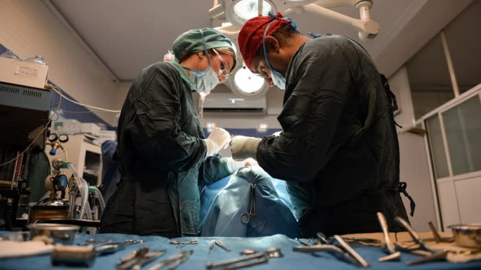 Staff operating on a patient at a plastic surgery clinic in Tehran, Iran