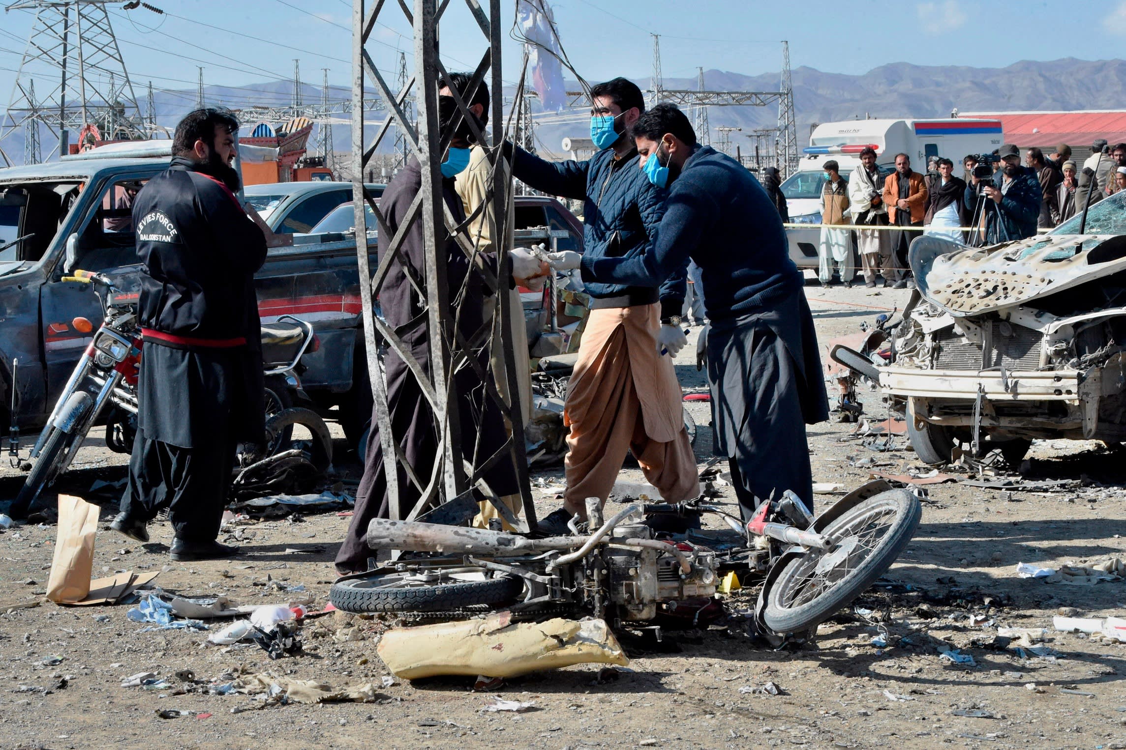 Security officials examine the site of a bomb blast in Balochistan province this week