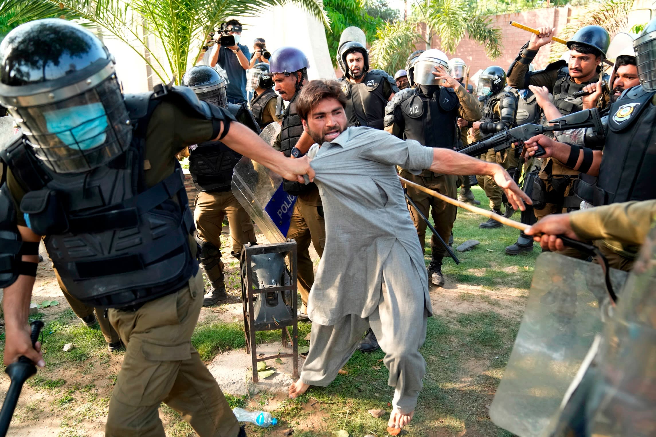Police detain a Khan supporter in Lahore last year