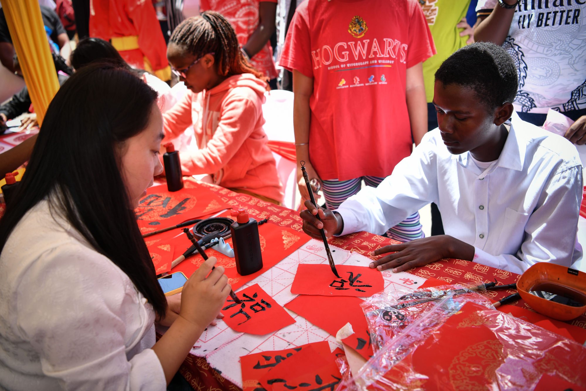 A visitor to Saturday’s event tries his hand at Chinese calligraphy. Photo: Xinhua
