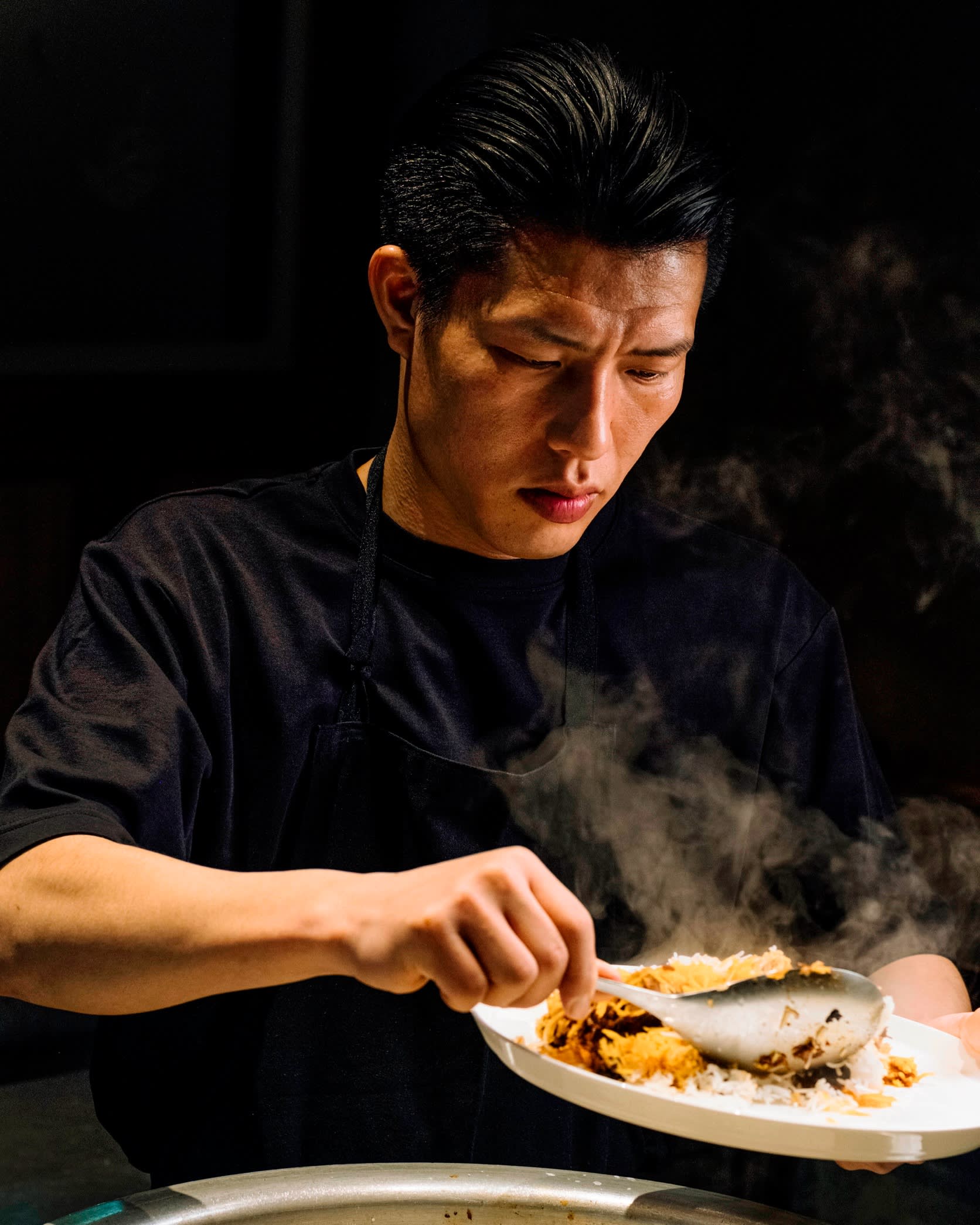 Chef Takamasa Osawa of Biryani Osawa scooping rice on to a plate