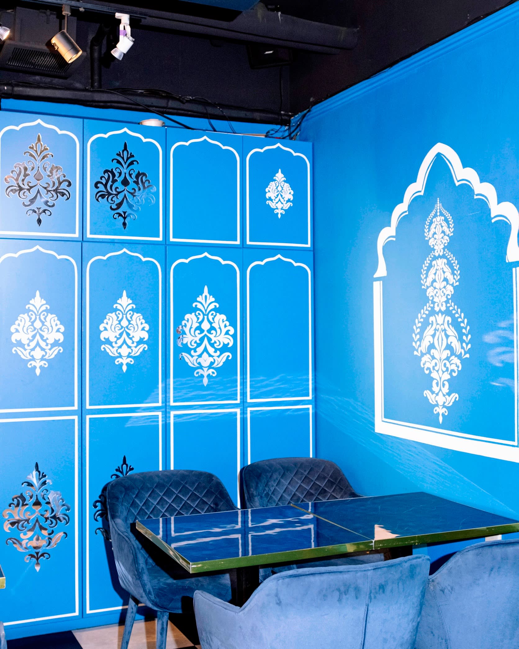 Blue and silver-filigree patterned walls at Mumbai
