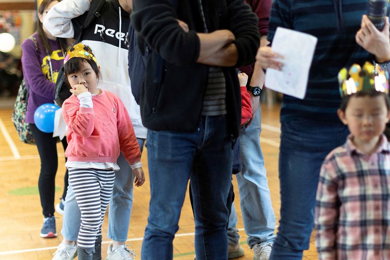 ENG_WOMEN'S_Analysis_03072024.3.JPG People line up at the Coronation Children's Fair organized to encourage newcomers from Hong Kong families to celebrate with the local community, at Trinity Church, in Sutton, London, April 29, 2023. (May James/Reuters)