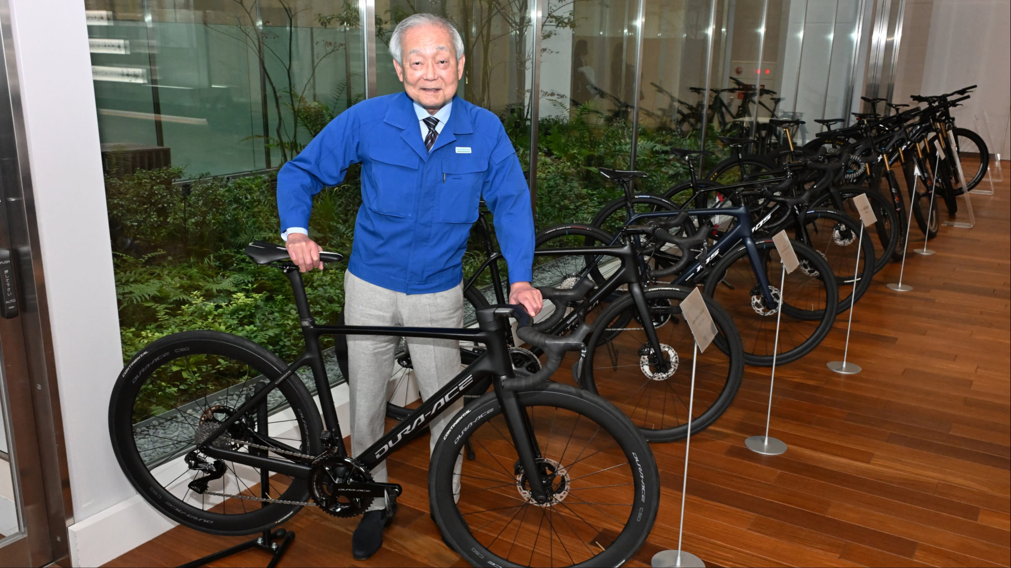Yozo Shimano standing beside bicycles