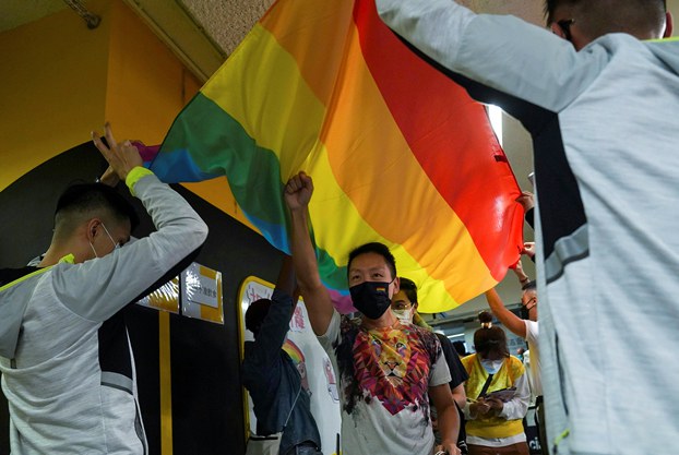 ENG_CHN_LaiKe_03062024.2.jpg Supporters of LGBTQ rights walk under a flag at the Rainbow Market in Hong Kong following the cancellation of the annual pride parade for the second year in a row due to the COVID-19 pandemic, Nov. 13, 2021. (Lam Yik/Reuters)