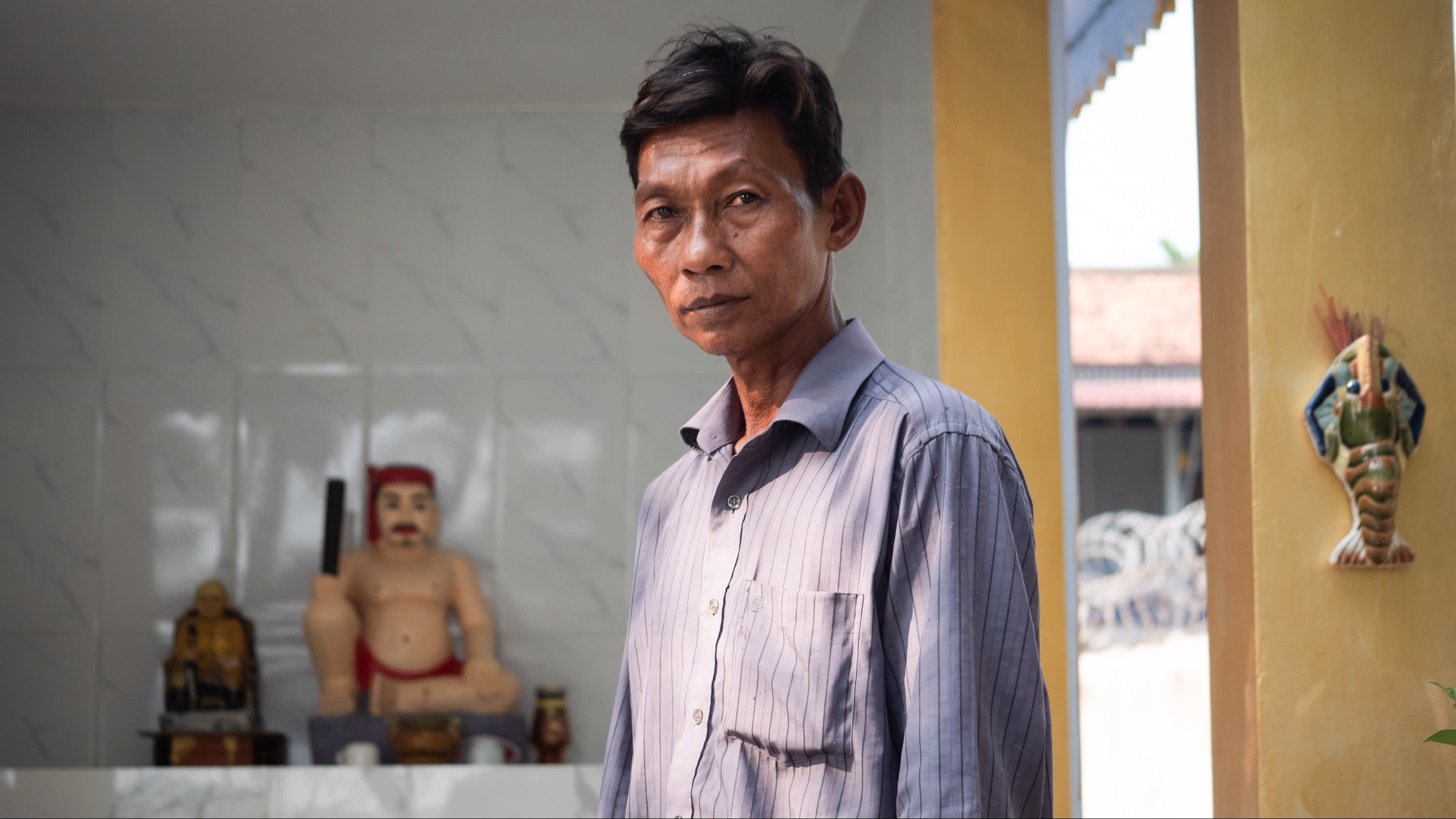 Motorbike taxi driver Mao Sarin looking at the camera