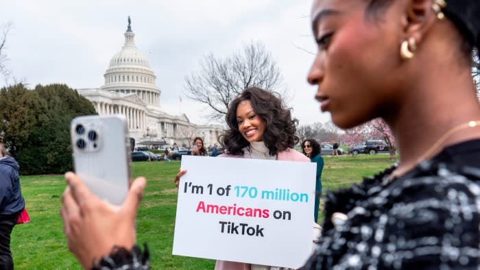 Devotees of TikTok, Mona Swain, center, and her sister, Rachel Swain, right, monitor voting at the Capitol in Washington