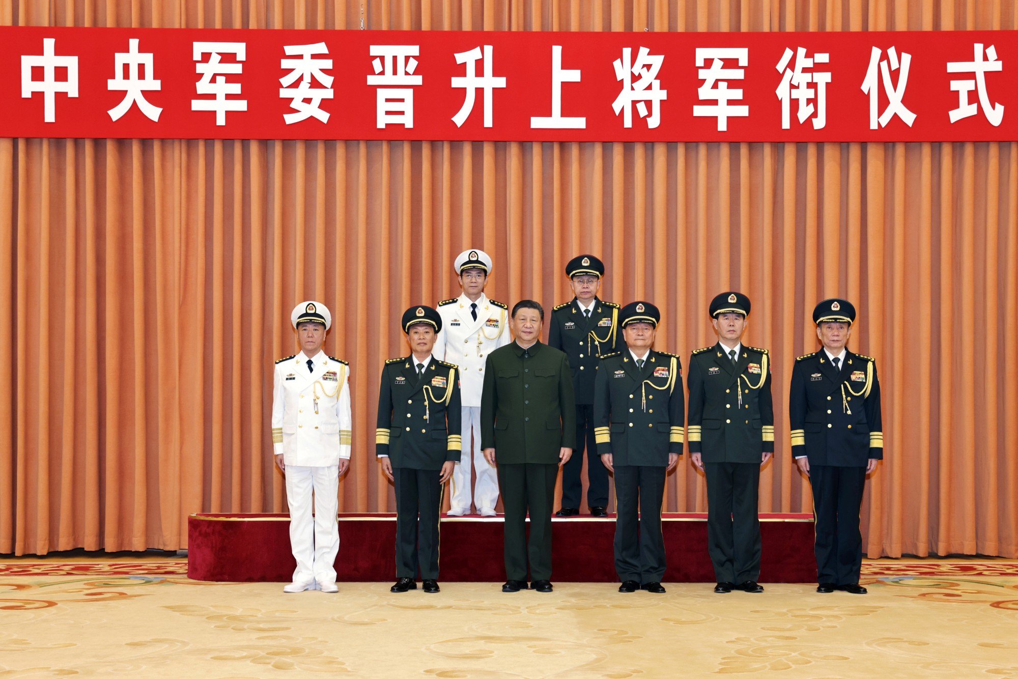 Xi Jinping (front row, centre) poses for a photo with top military brass and two newly promoted generals, Wang Renhua (back row, left) and Xiao Tianliang (back row, right), in Beijing on Thursday. Photo: Xinhua