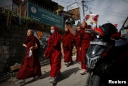 Tibetan nuns participate in a protest march held to mark the 65th anniversary of the Tibetan uprising against Chinese rule, in the northern hill town of Dharamsala, India, March 10, 2024.