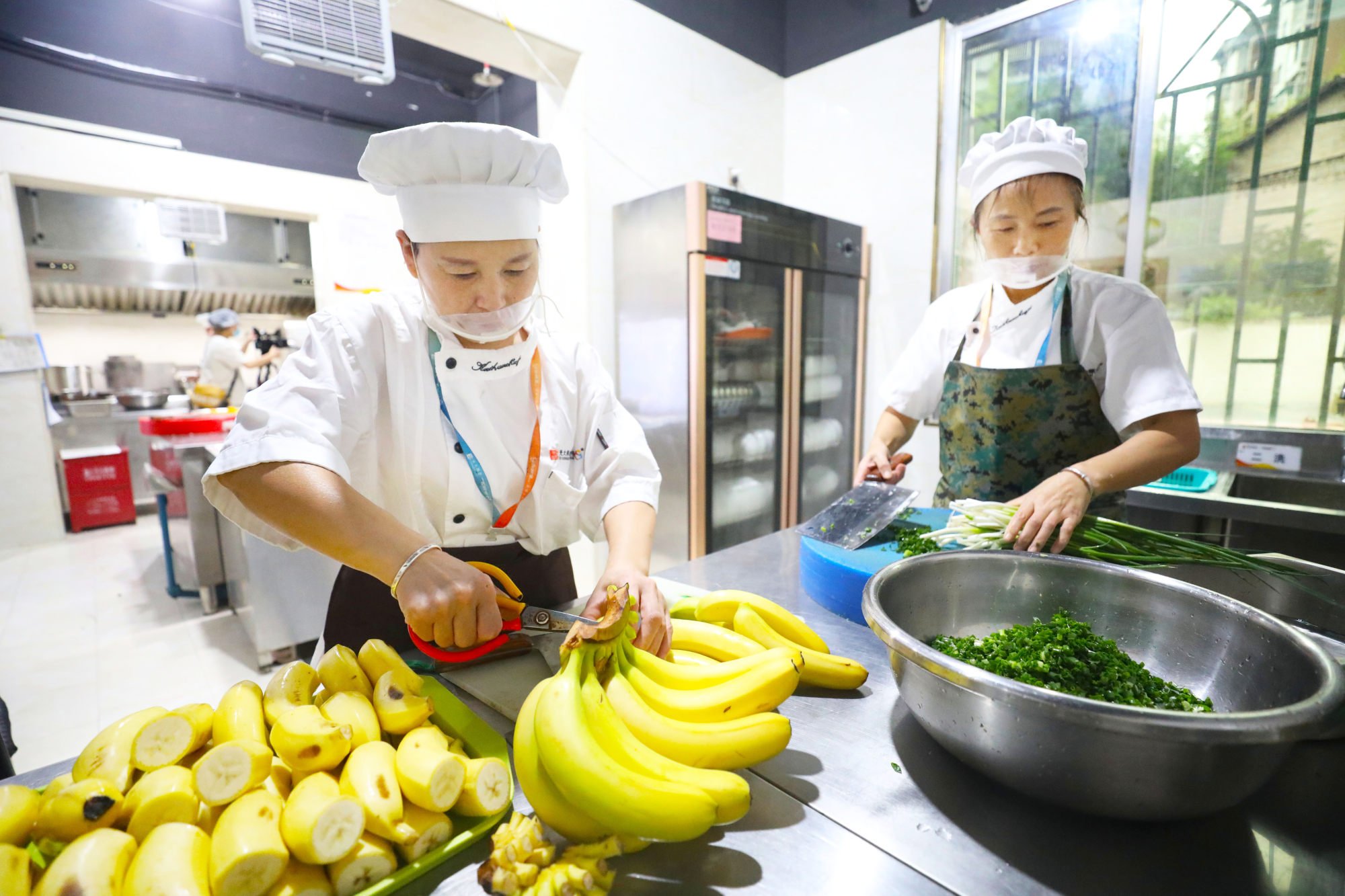 Workers prepare food at a community canteen for the elderly in Chongqing, China in July 2023. Photo: CFOTO/Future Publishing via Getty Images