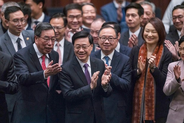 ENG_CHN_HKNatSec_03292024.3(1).jpg Hong Kong's Chief Executive John Lee (C) applauds with lawmakers following the passing of Article 23 legislation at the Legislative Council in Hong Kong on March 19, 2024. (Louise Delmotte/AP)