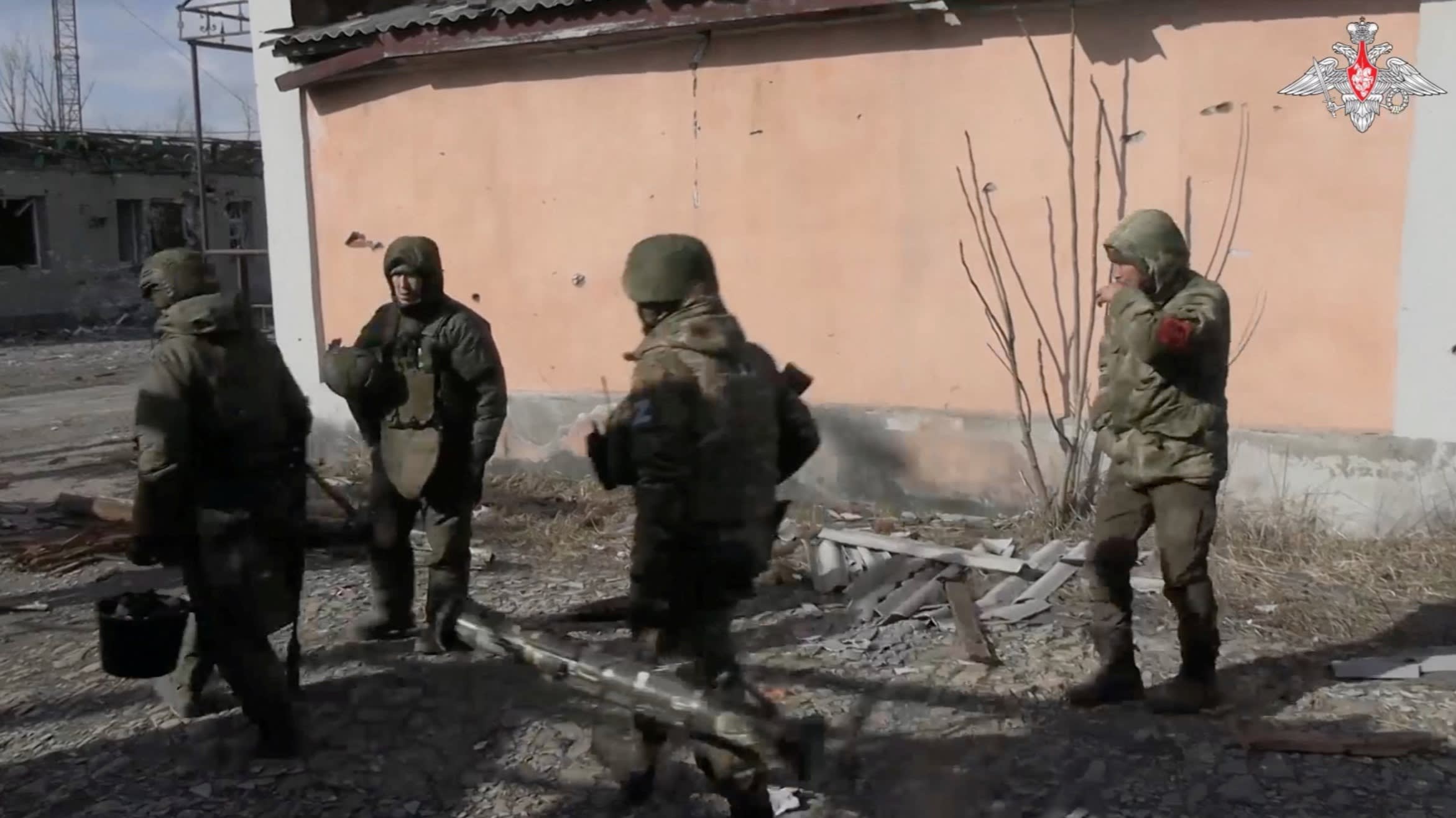 Members of the Russian military near a damaged building in a social media post from the Russian defence ministry released on February 22 2024