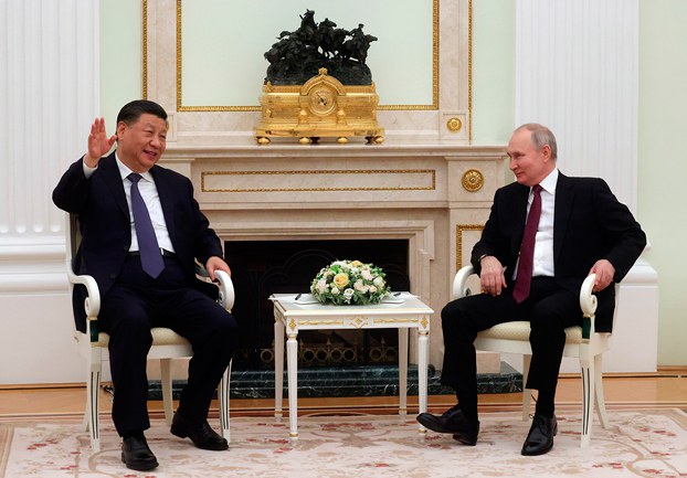 Chinese President Xi Jinping (L) gestures while speaking to Russian President Vladimir Putin during a meeting at the Kremlin in Moscow, March 20, 2023. (Sergei Karpukhin/SputnikKremlin pool photo via AP)