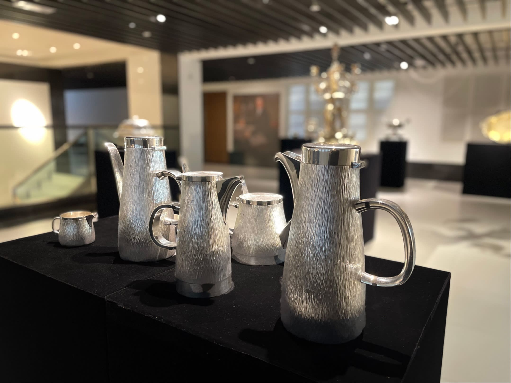 Some silver teapots with a rough finish
