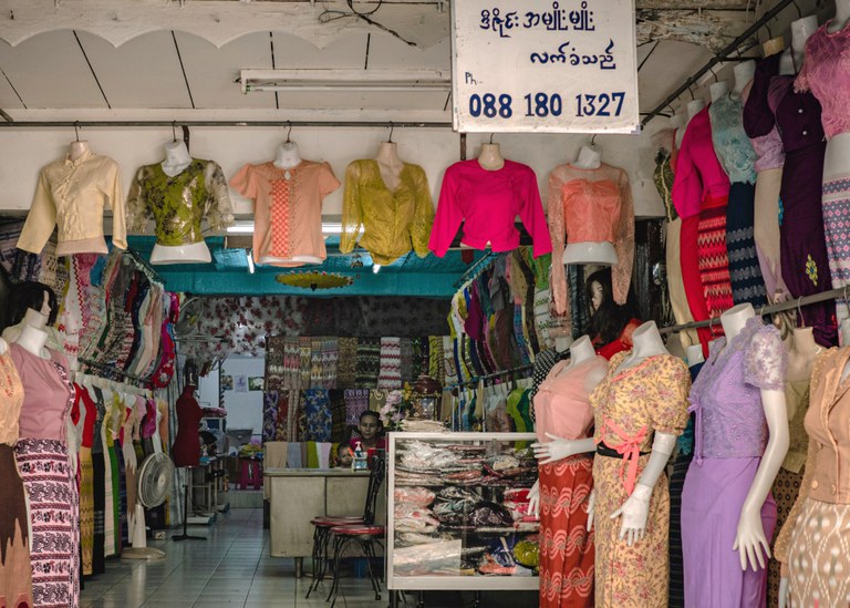 BUR-migrant-workers-thailand.3.jpeg A Burmese-language sign hangs in a clothing store operated by Yi Win, a Myanmar man who immigrated shortly before the February 2021 coup, in his shop in the Phra Khanong section of Bangkok, March 13, 2024. (Wissarut Verasopon/Thai News Pix/BenarNews)