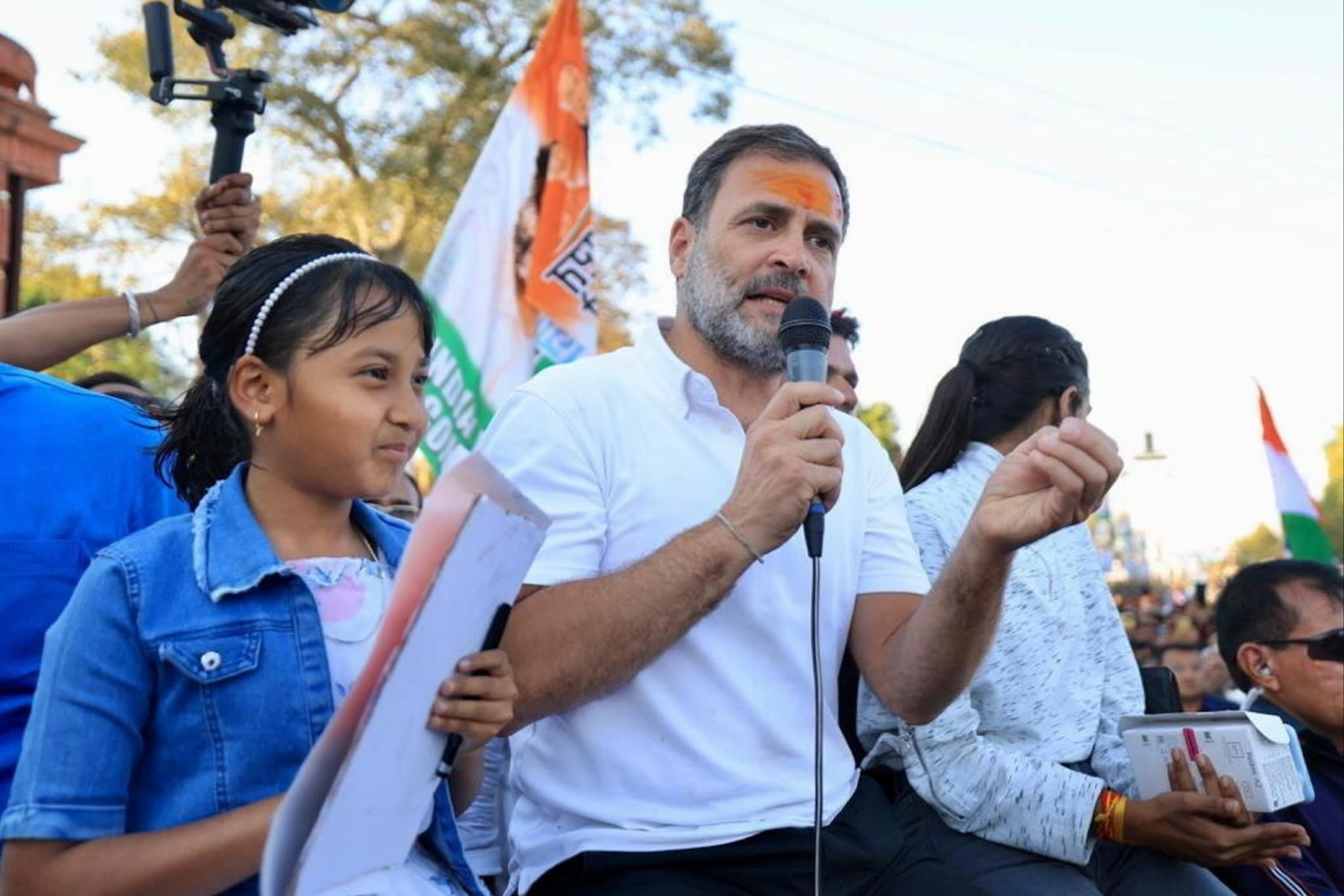 Gandhi speaking into a microphone