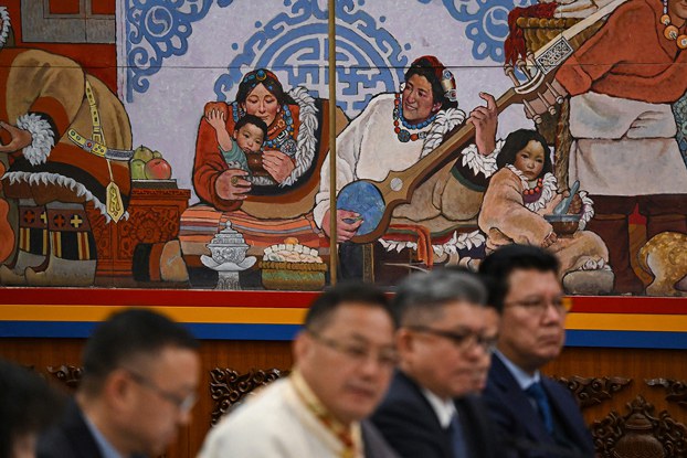 ENG_TIB_TibetansinGovt_03052024.4.jpg Delegates sit below a decoration in the Tibet Hall of the Great Hall of the People during the Tibet delegation meeting at the National People's Congress at the Great Hall of the People in Beijing, March 6, 2024. (Greg Baker/AFP)