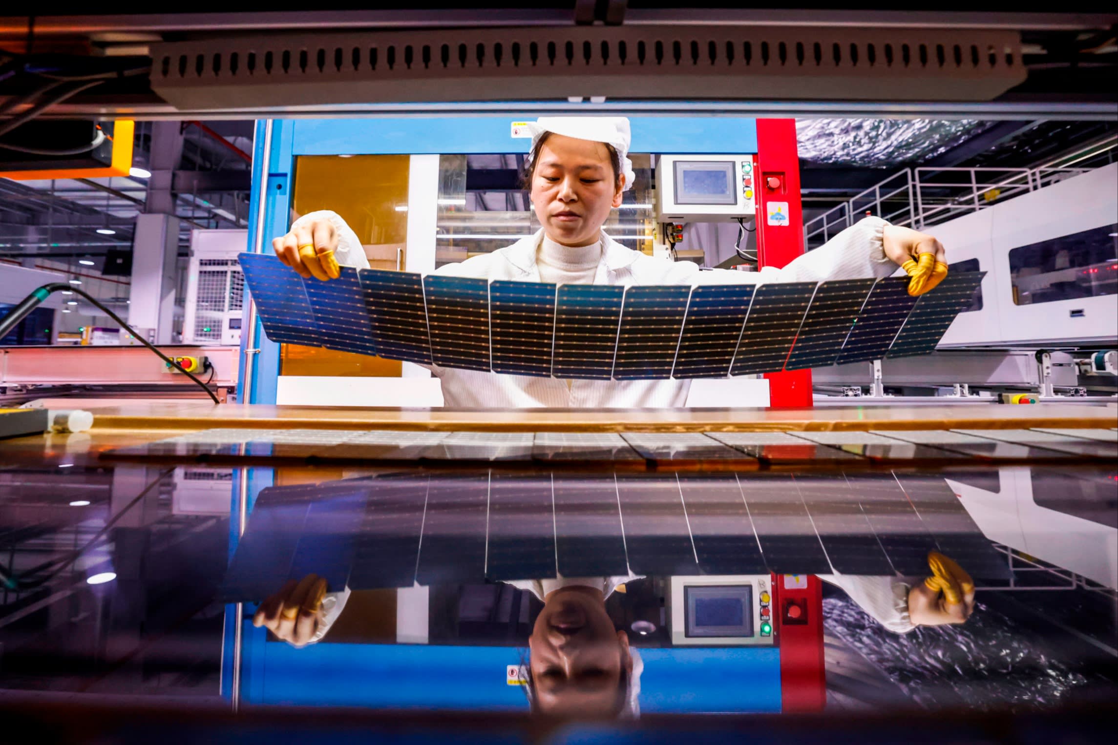 Solar photovoltaic panel components being produced at a factory in Jiangsu province, China