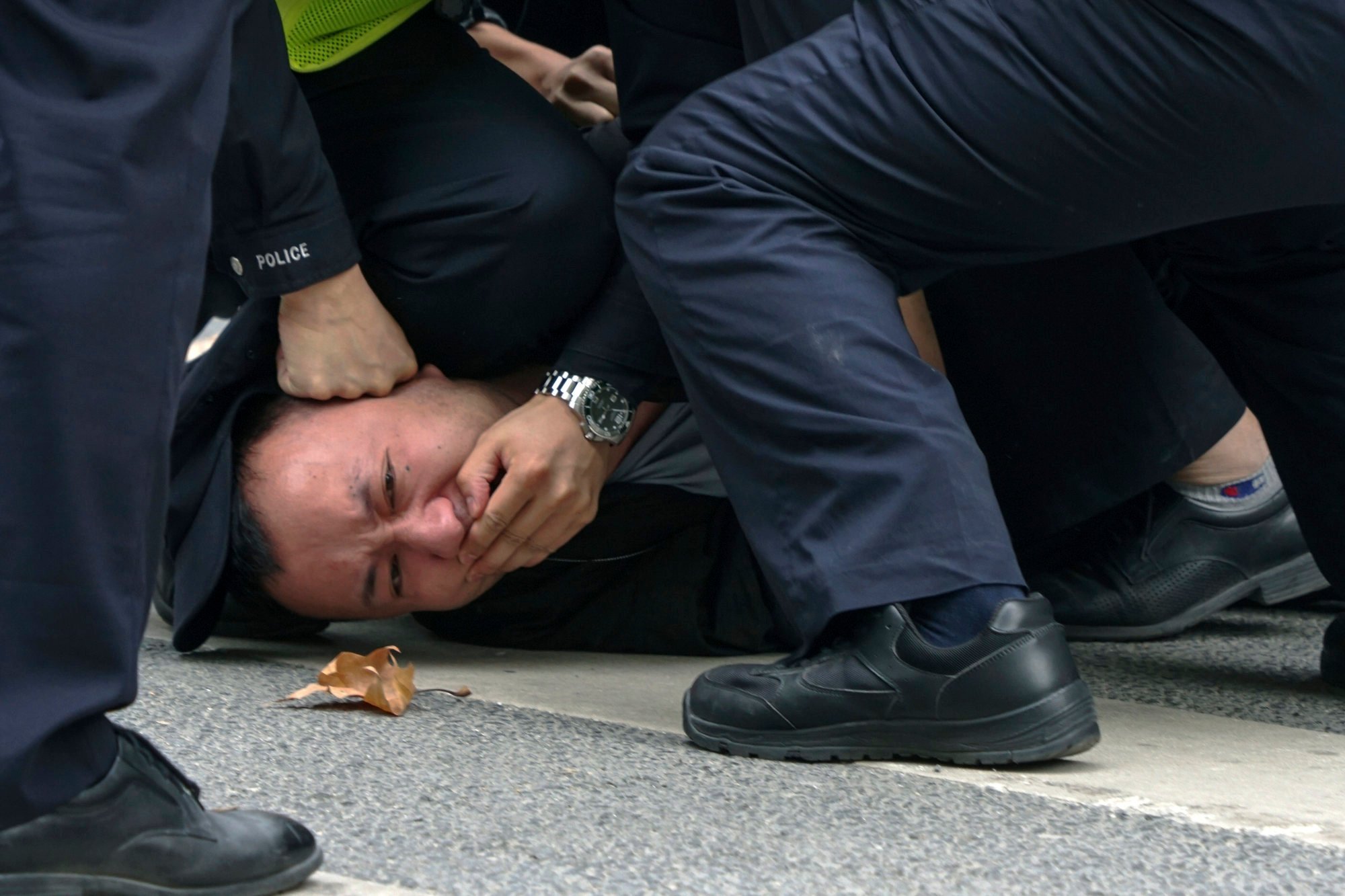 Chinese police pin down and arrest a man during a protest on a street in Shanghai while the country’s zero-Covid policy was in place. Photo: AP
