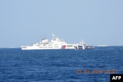 This photo released by the Philippine Bureau of Fisheries and Aquatic Resources on March 25, 2024 shows a Chinese Coast Guard ship blocking a Philippine ship near Thitu Island, in the Spratly Islands, in the disputed South China Sea.