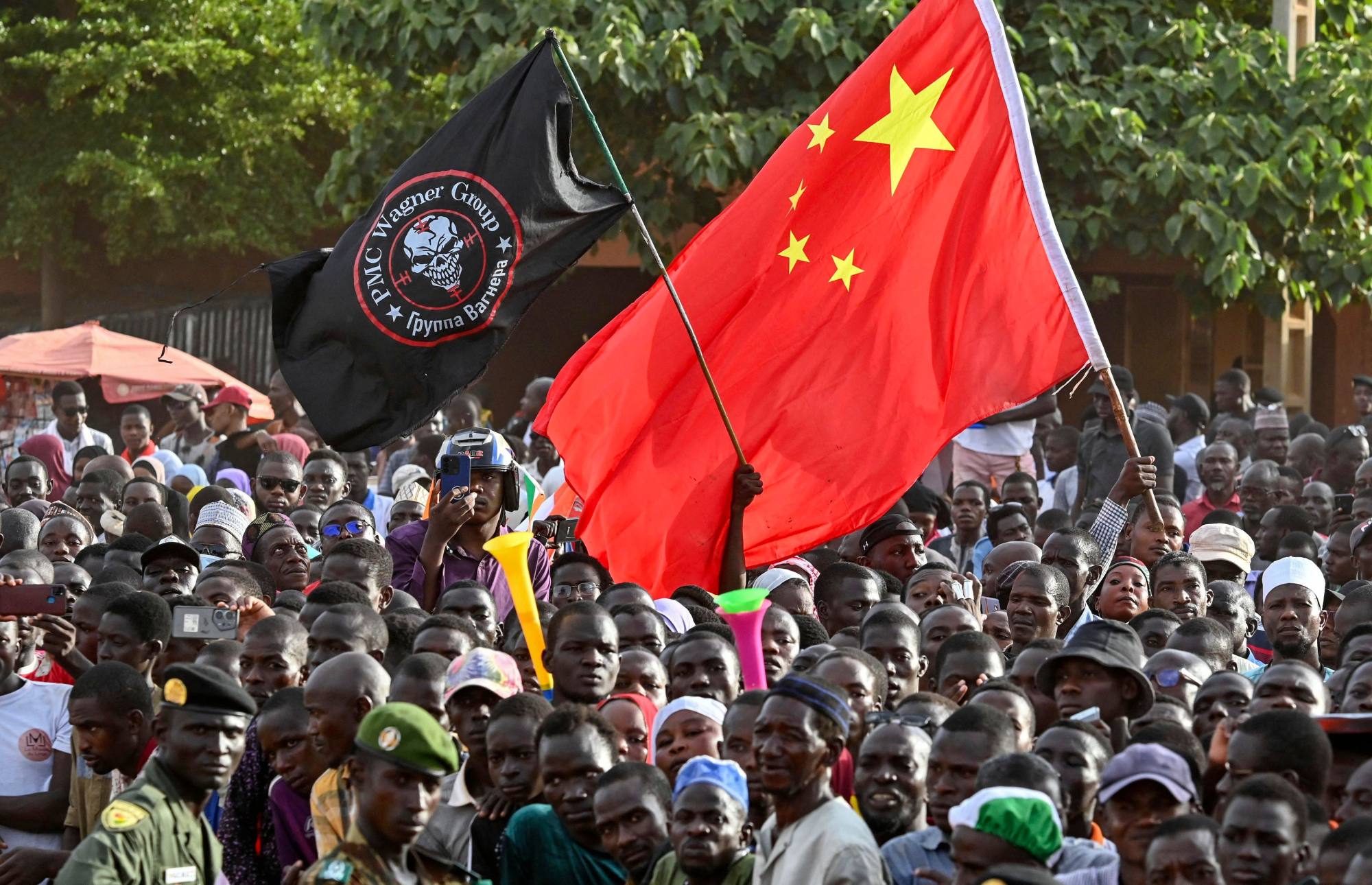 Supporters of the Niger junta wave a Chinese flag and one of the Russian Wagner group at a protest last year demanding the French military leaves the country. Photo: AFP