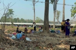 FILE - Residents from eastern Myanmar are seen after fleeing into Thailand's Tak Province from Myanmar's Myawaddy district, April 6, 2023.