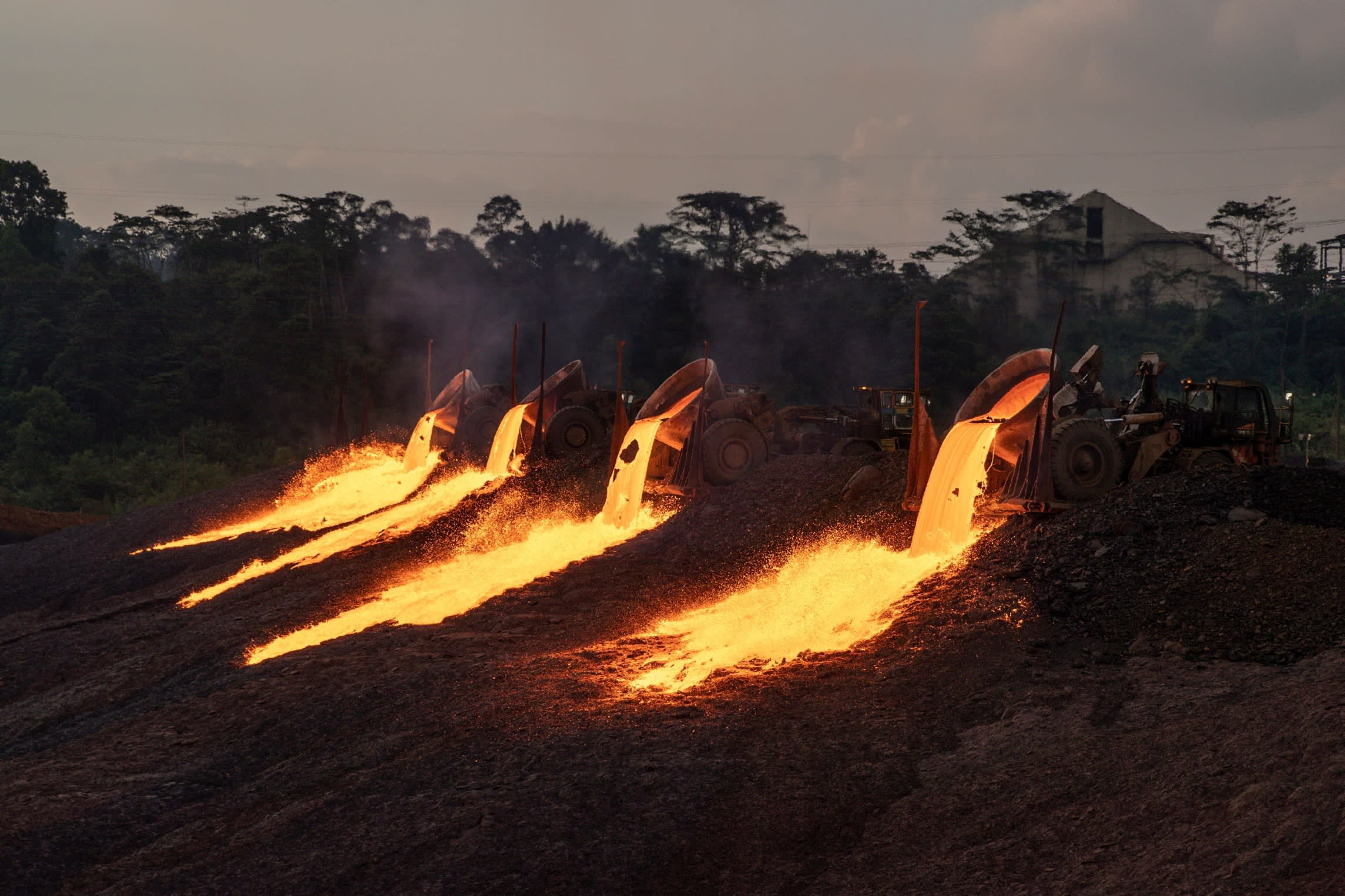 Slag flows from trucks at a nickel processing site in Indonesia