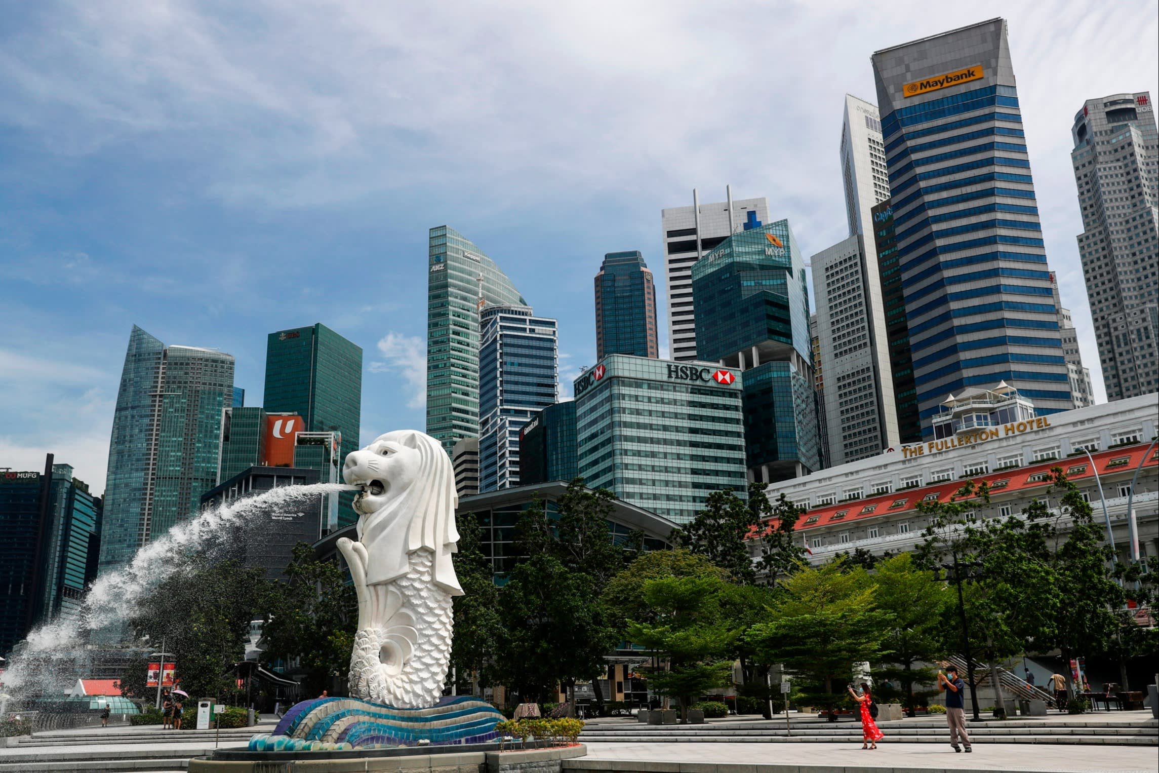 The Merlion statue along the Marina Bay area in Singapore. In the background are skyscrapers 